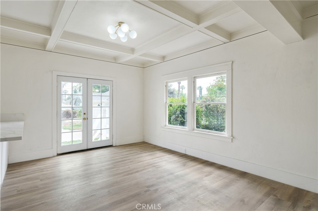 4415 12th Street Riverside, CA 92501 - Photo 13 of 33 an empty room with wooden floor and windows