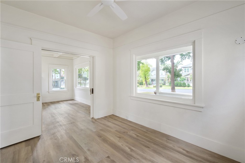 4415 12th Street Riverside, CA 92501 - Photo 15 of 33 an empty room with wooden floor and windows