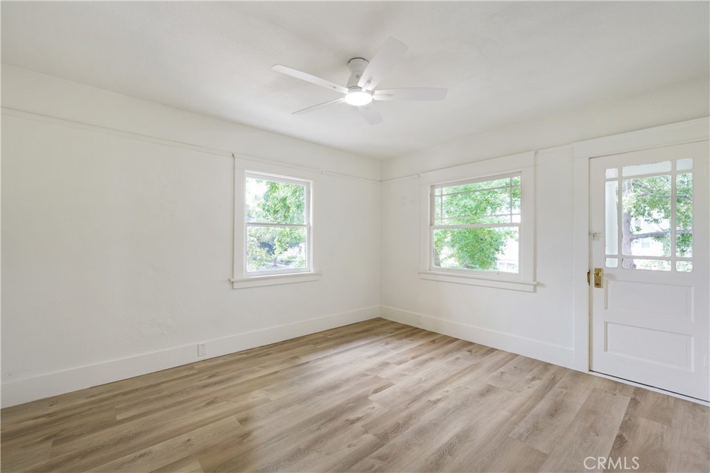 4415 12th Street Riverside, CA 92501 - Photo 19 of 33 an empty room with wooden floor and windows