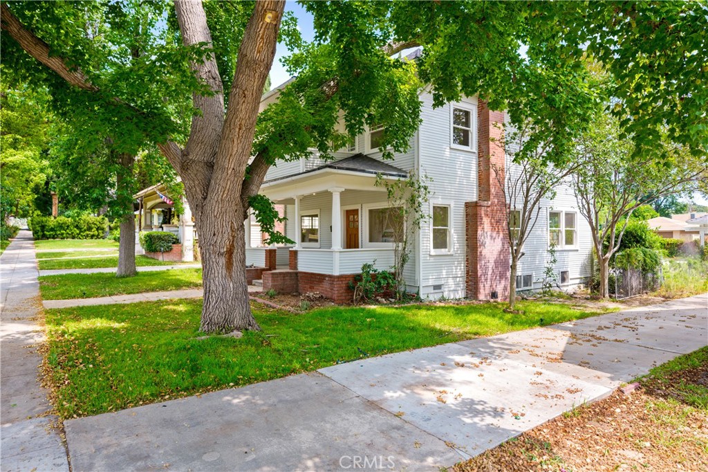 4415 12th Street Riverside, CA 92501 - Photo 2 of 33 a front view of a house with a yard and trees