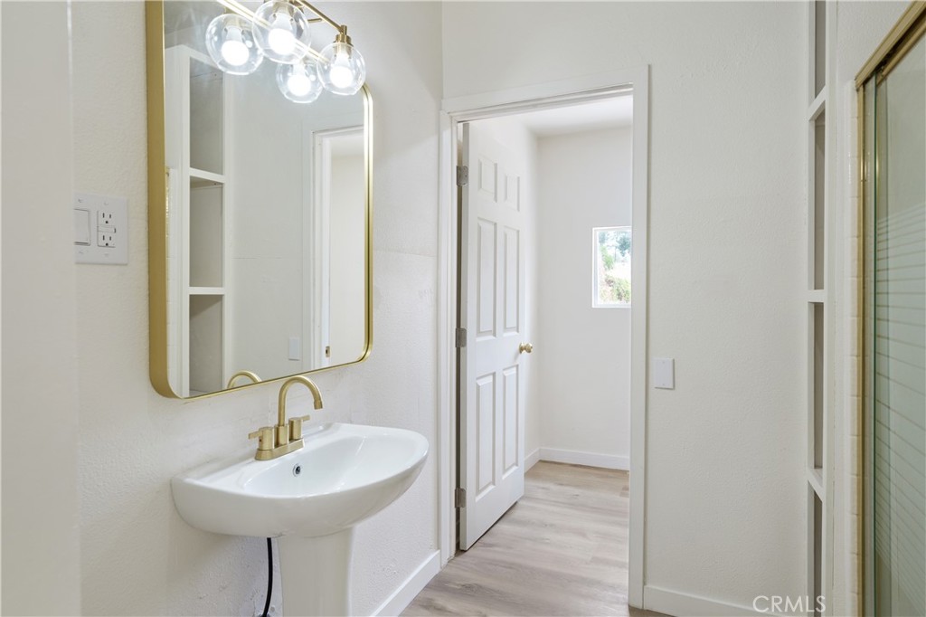 4415 12th Street Riverside, CA 92501 - Photo 25 of 33 a bathroom with a sink and a mirror