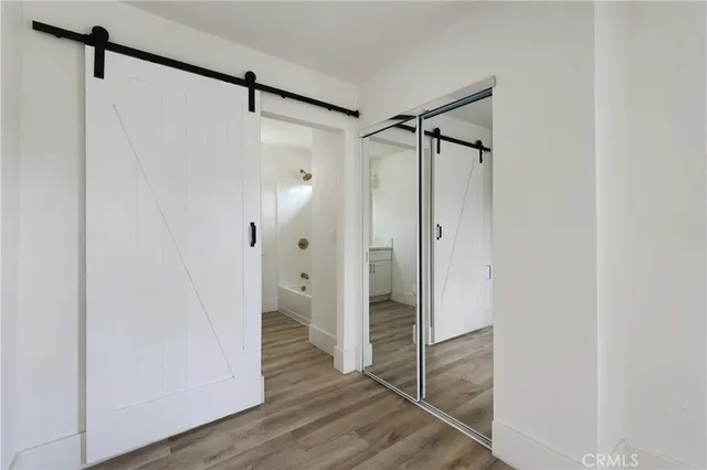a bathroom with a glass shower door and a glass door