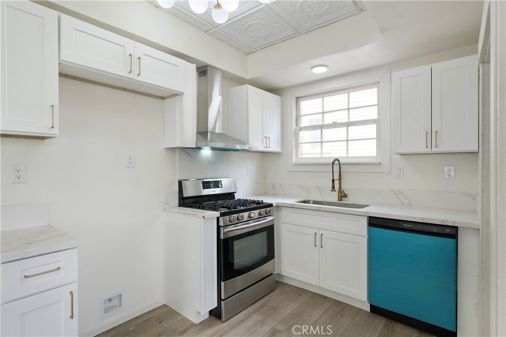 4415 12th Street Riverside, CA 92501 - Photo 9 of 33 a kitchen with granite countertop white cabinets and white appliances