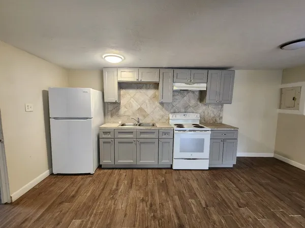 a kitchen with a refrigerator and a stove