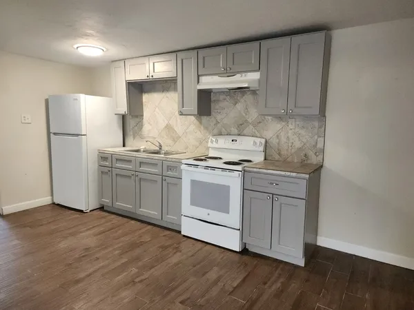 a kitchen with a white cabinets and white appliances
