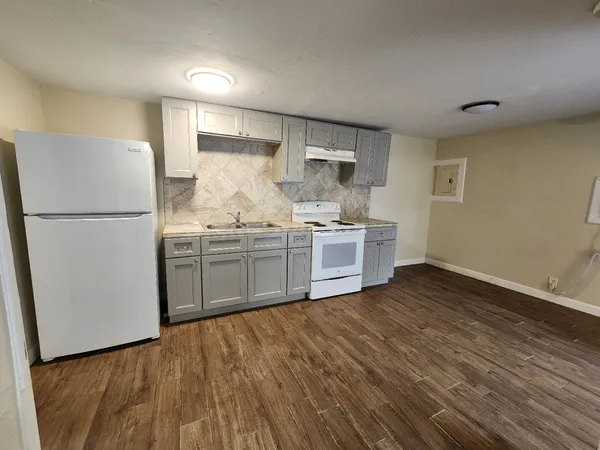 a kitchen with stainless steel appliances a refrigerator sink and cabinets