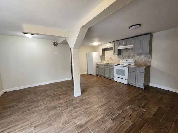 a kitchen with kitchen island granite countertop a stove and a refrigerator