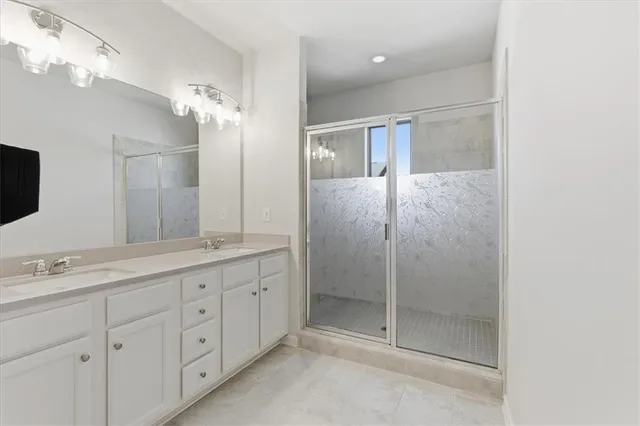 a bathroom with a double vanity sink and mirror