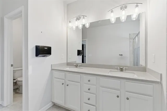 a bathroom with a double vanity sink and mirror