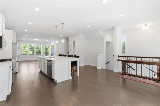 a view of a kitchen with a sink and a stove top oven
