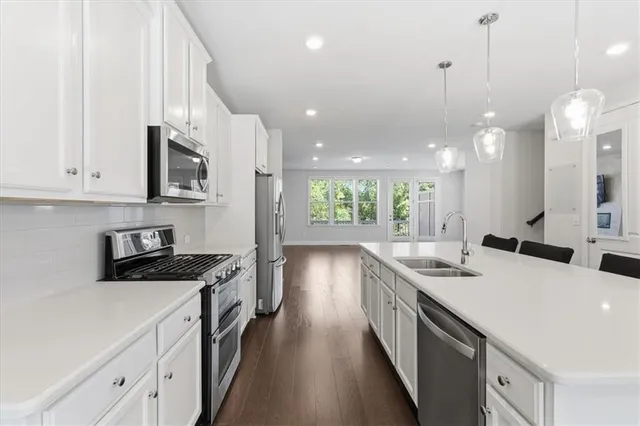 a kitchen with a sink stove and cabinets