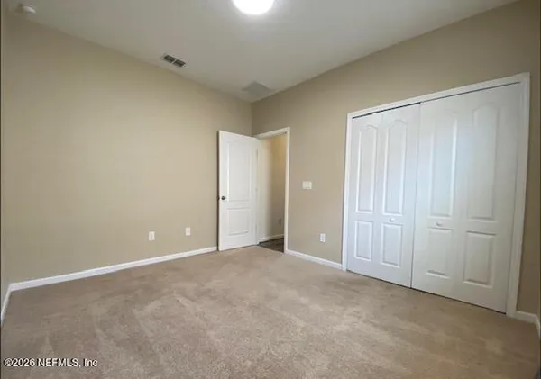 an empty room with closet area