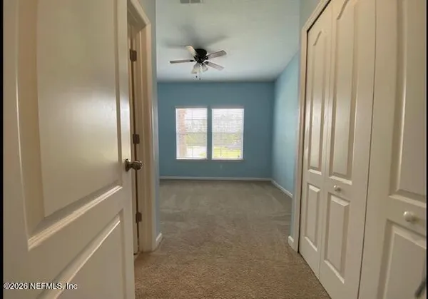 a view of an empty room and a window
