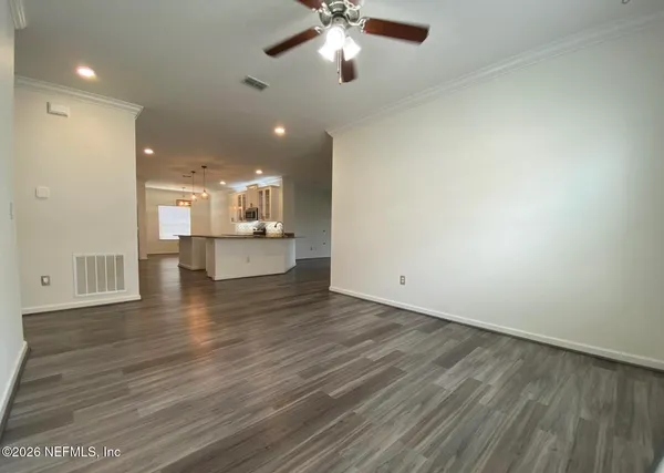 a view of a kitchen with a sink and dishwasher a refrigerator with wooden floor