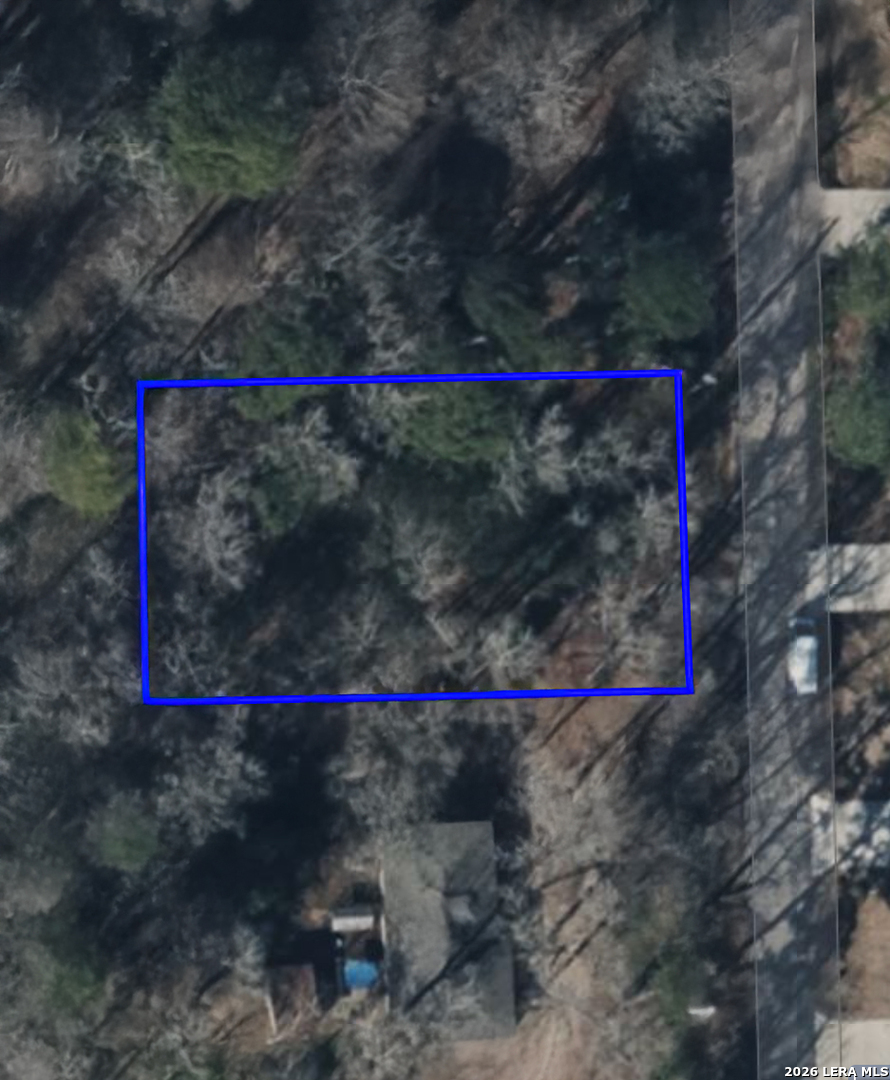 Tbd Austin Road Willis, TX 77378 - Photo 1 of 3 a street sign that is sitting in front of a house