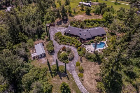 an aerial view of a house with a yard