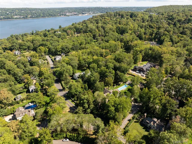 an aerial view of a houses with a lake view