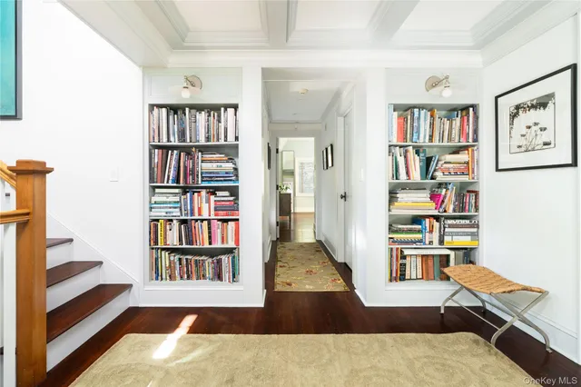 a living room with furniture and a book shelf