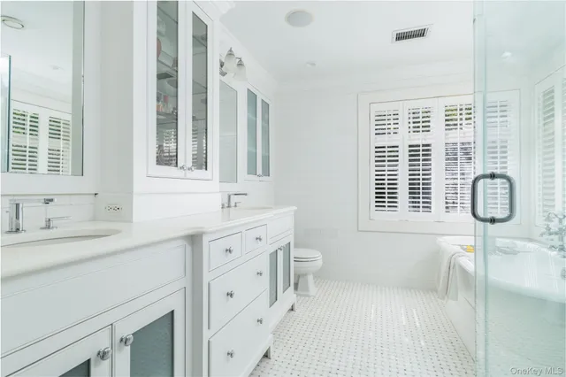 a bathroom with a tub sink and mirror