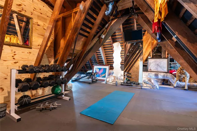 a living room with a table chairs and a dining table with wooden floor