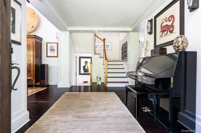 a living room with stainless steel appliances furniture a fireplace and a flat screen tv