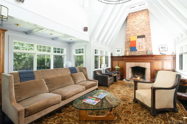 a living room with furniture a fireplace and a large window