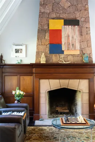 a living room with a fireplace and a flat screen tv
