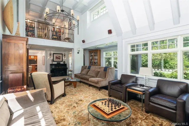 a living room with furniture a rug and a chandelier