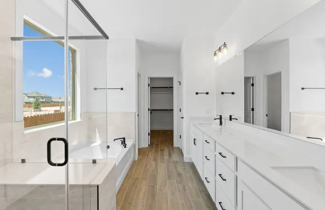 a large kitchen with kitchen island a sink stainless steel appliances and cabinets