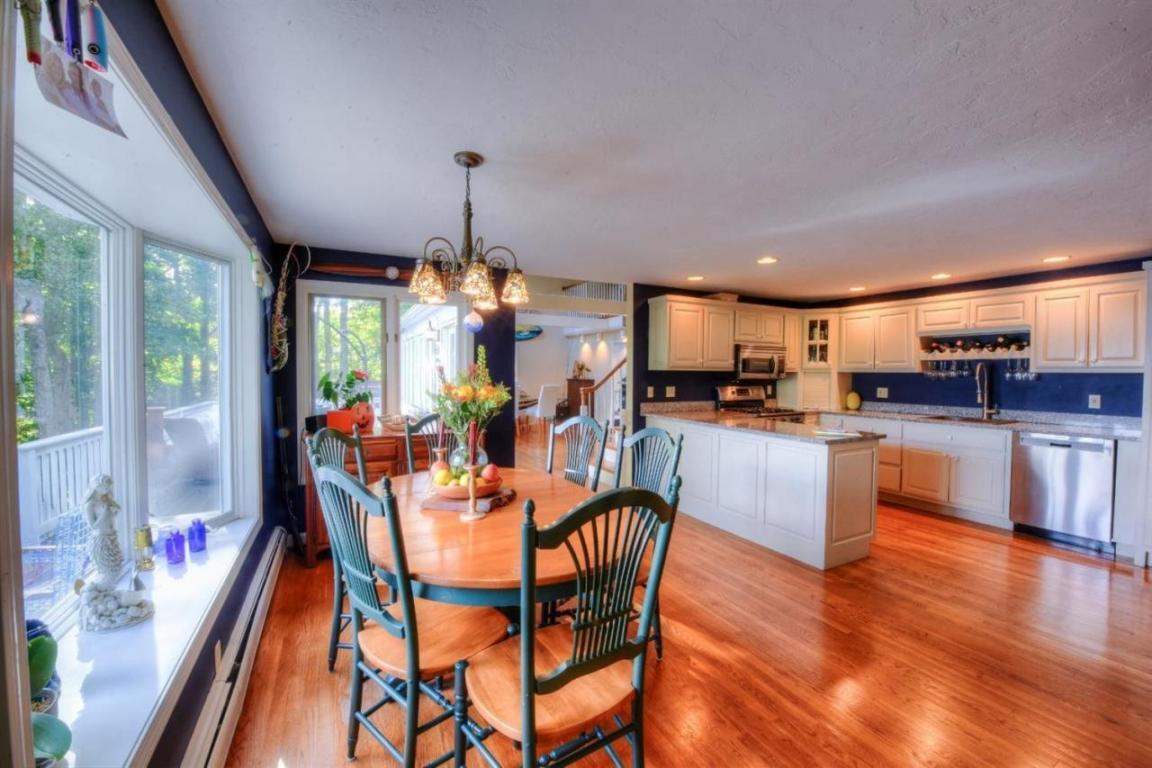26 Cove Road Forestdale, MA 02644 - Photo 11 of 35 a view of a dining room and livingroom with furniture wooden floor a chandelier