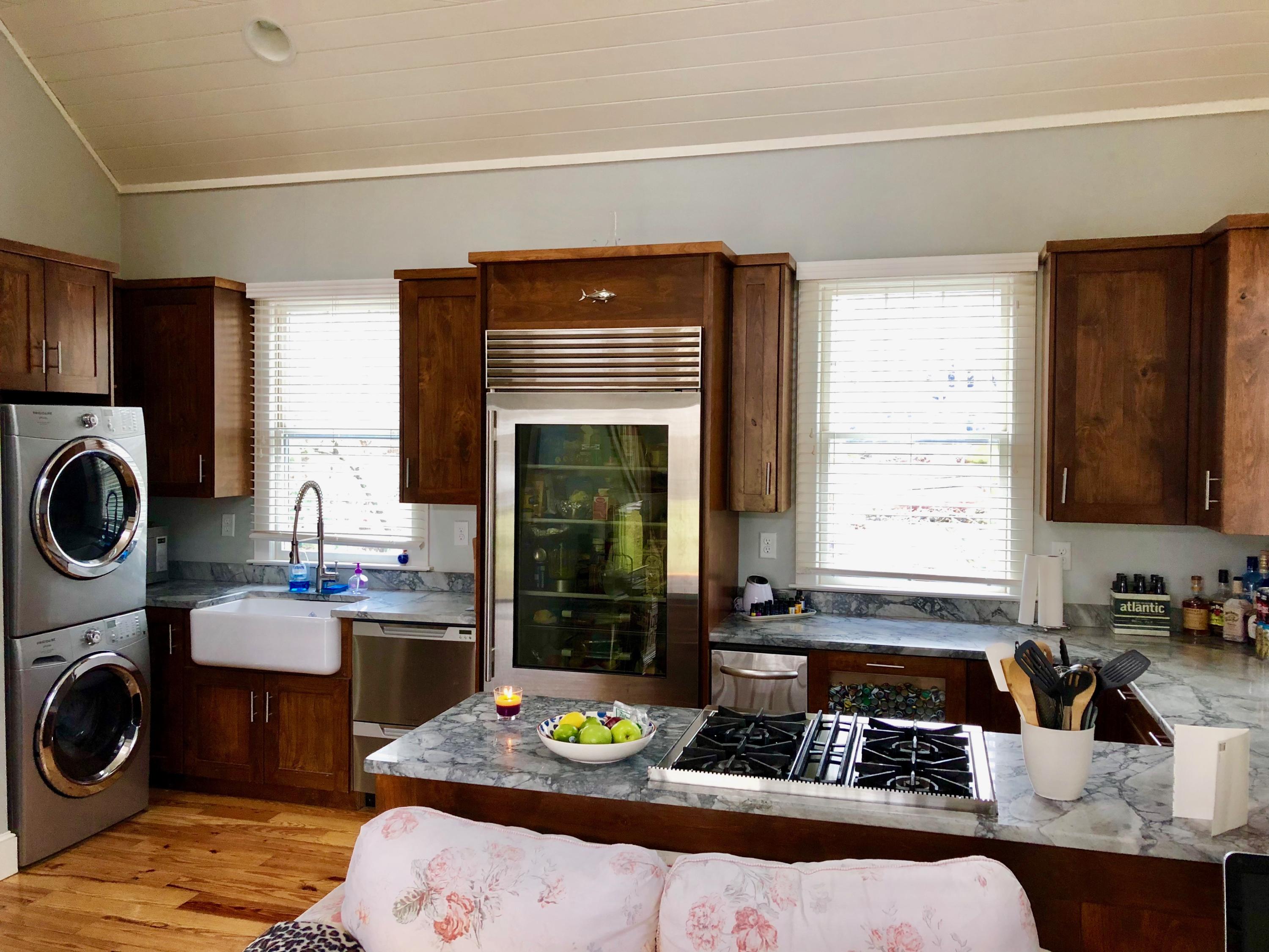 26 Cove Road Forestdale, MA 02644 - Photo 23 of 35 a kitchen with kitchen island granite countertop a sink stove and cabinets