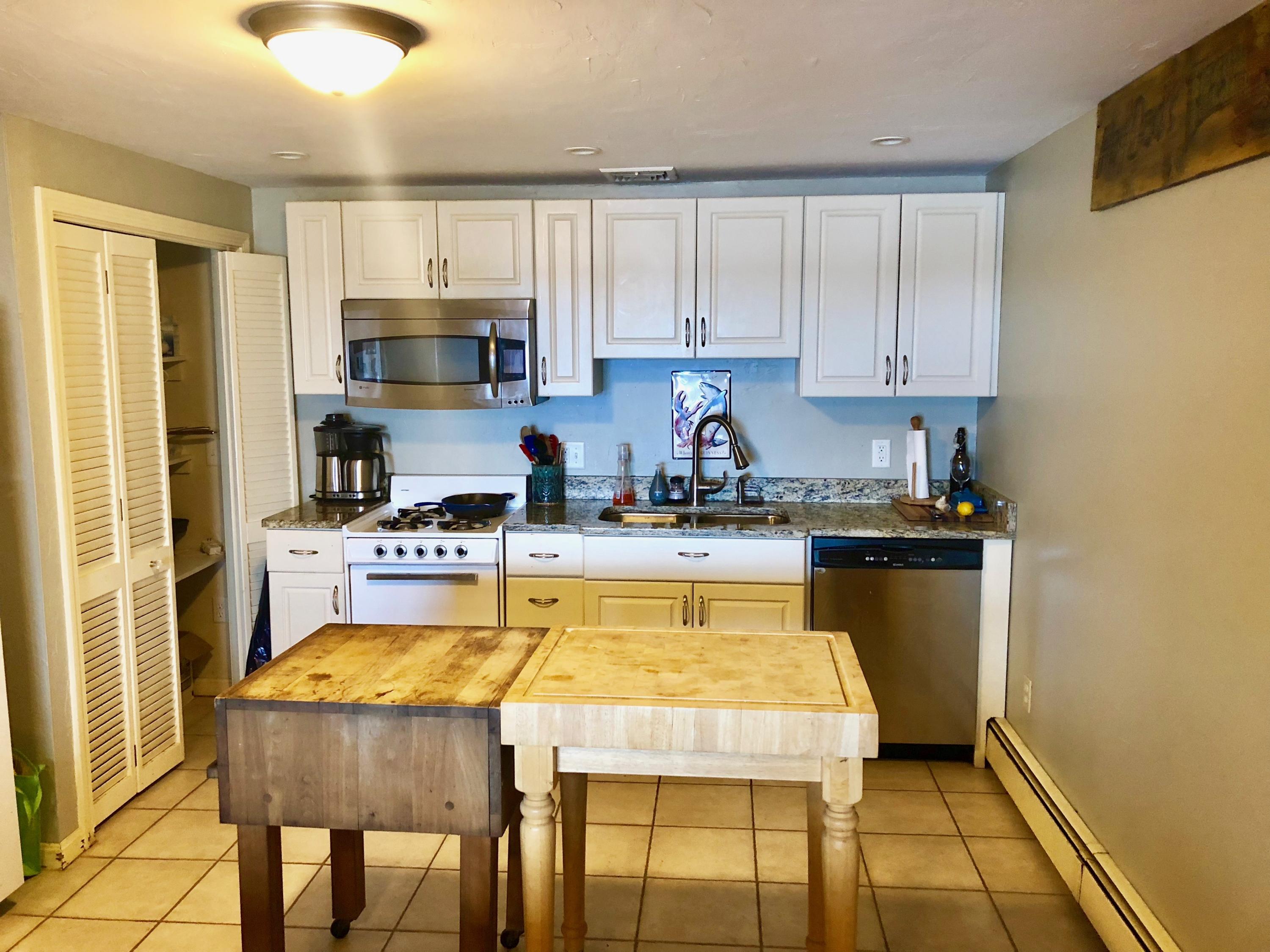 26 Cove Road Forestdale, MA 02644 - Photo 31 of 35 a kitchen with a refrigerator a stove a sink and cabinets