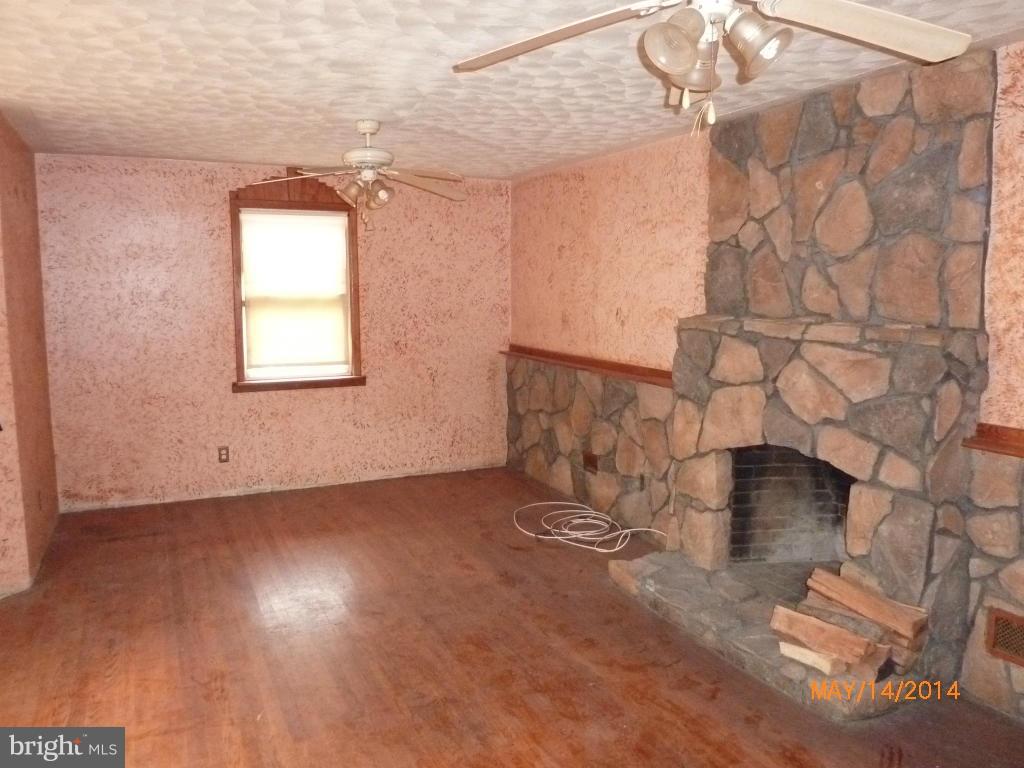 8321 Philadelphia Road Baltimore, MD 21237 - Photo 5 of 15 an empty room with wooden floor and windows