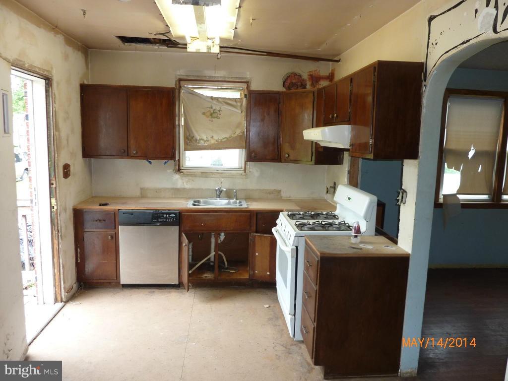 8321 Philadelphia Road Baltimore, MD 21237 - Photo 7 of 15 a kitchen with stainless steel appliances granite countertop a stove a sink and a refrigerator