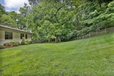 a view of a house with backyard and garden