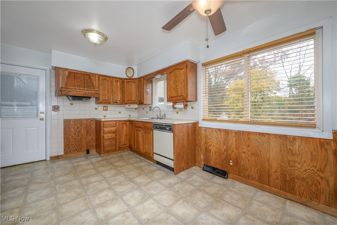 455 Rutland Street Akron, OH 44305 - Photo 10 of 28 Kitchen featuring oak cabinets, ceiling fan, dishwasher, sink, and decorative backsplash