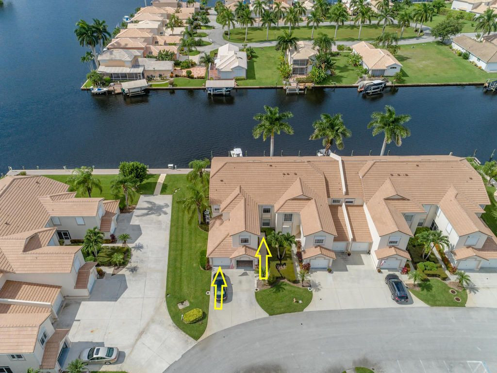 237 Sunrise Cay, Unit 101 Naples, FL 34114 - Photo 1 of 18 an aerial view of a house with garden space and lake view
