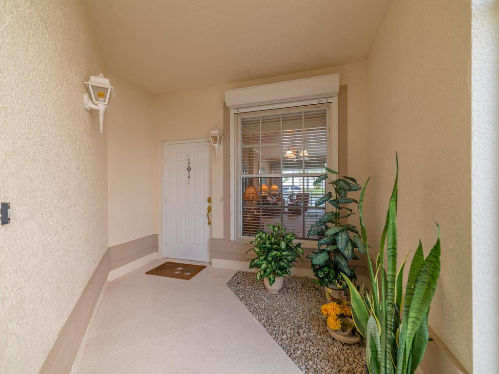 237 Sunrise Cay, Unit 101 Naples, FL 34114 - Photo 3 of 18 a view of a potted plants in front of a door