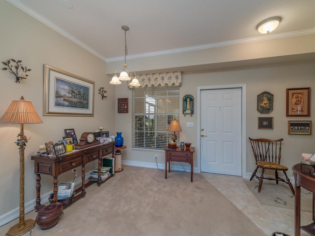 237 Sunrise Cay, Unit 101 Naples, FL 34114 - Photo 5 of 18 a view of a workspace with furniture and a livingroom