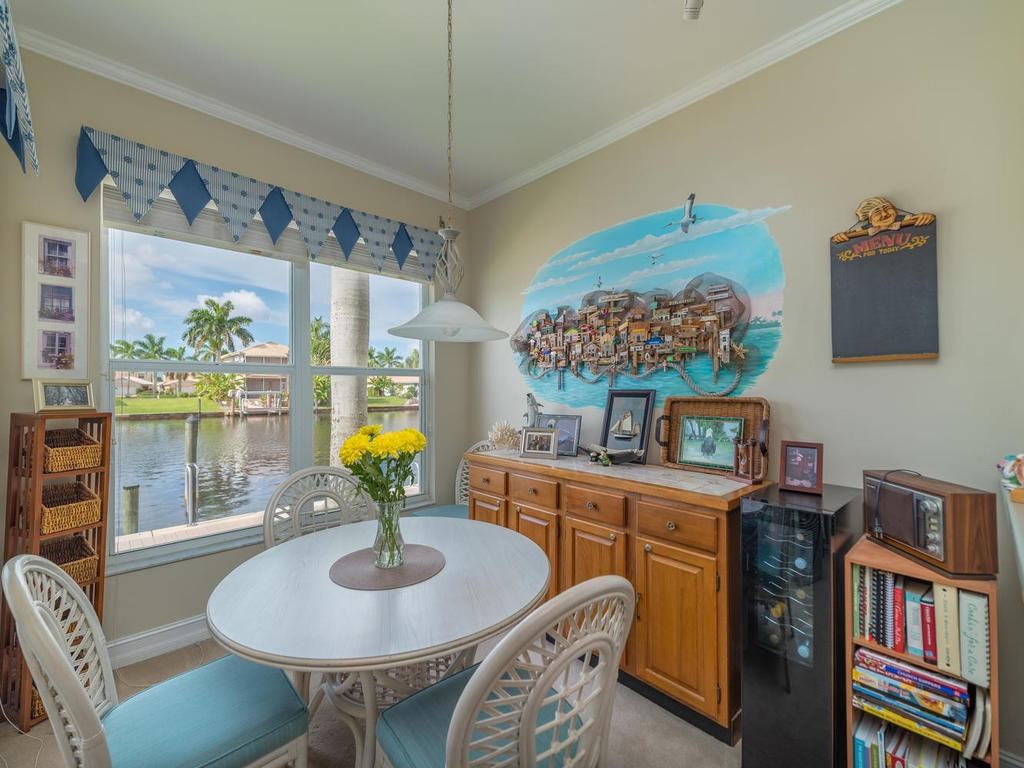 237 Sunrise Cay, Unit 101 Naples, FL 34114 - Photo 7 of 18 a living room with furniture and a table