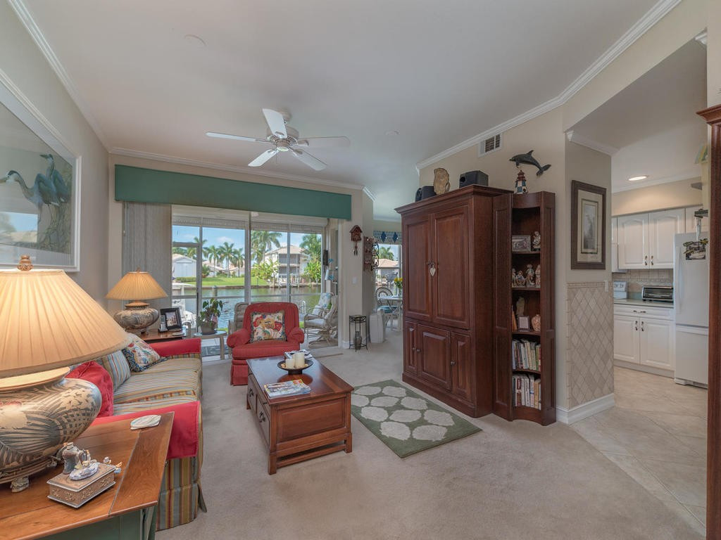 237 Sunrise Cay, Unit 101 Naples, FL 34114 - Photo 10 of 18 a living room with furniture and a flat screen tv
