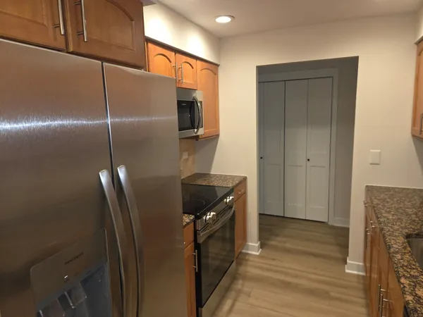 a kitchen with metallic refrigerator freezer and a dishwasher