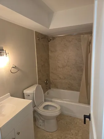 a bathroom with a toilet a sink and shower