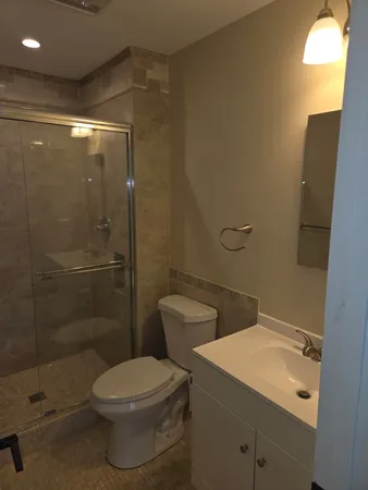 a bathroom with a toilet a sink and shower