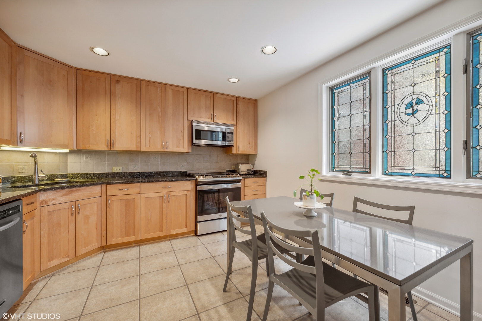 55 West Goethe Street, Unit 1251 Chicago, IL 60610 - Photo 13 of 28 a kitchen with stainless steel appliances granite countertop a stove top oven a sink dishwasher and cabinets with wooden floor