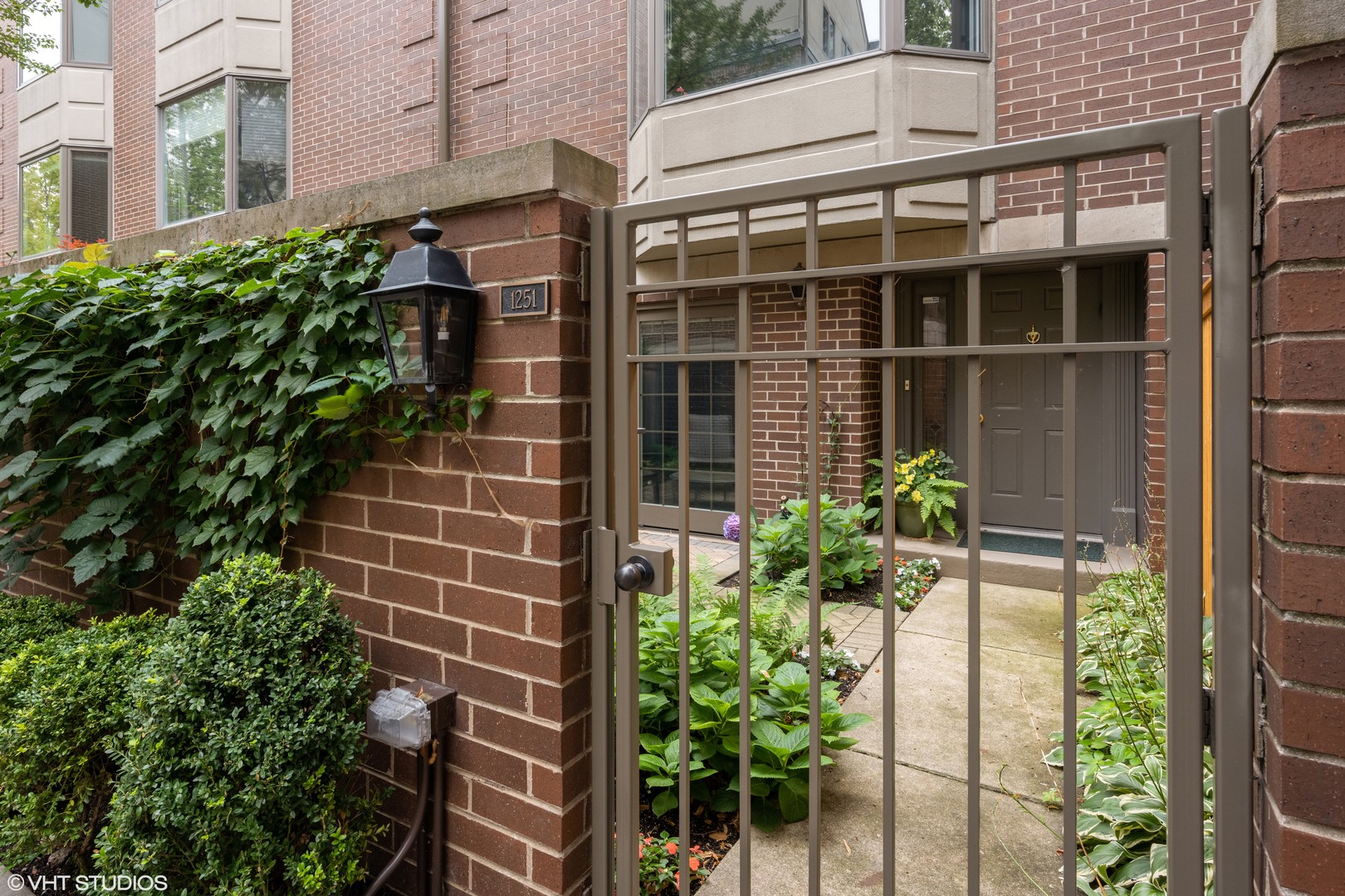 55 West Goethe Street, Unit 1251 Chicago, IL 60610 - Photo 2 of 28 a flower garden is sitting in front of a building