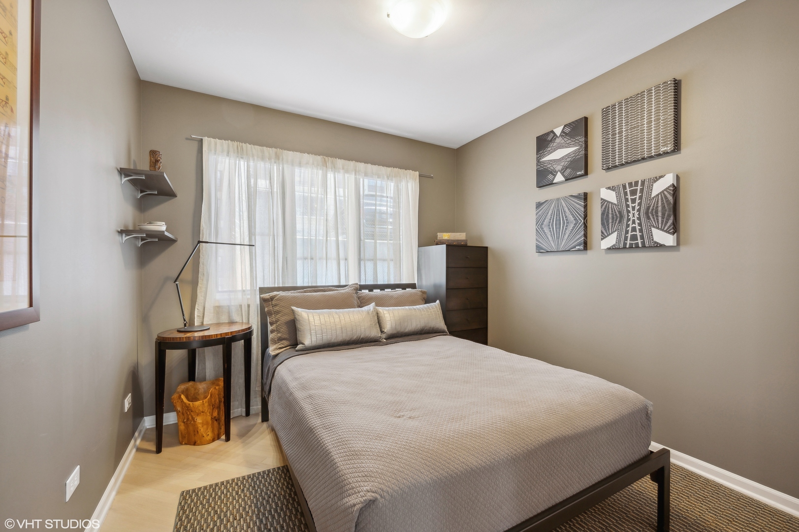 55 West Goethe Street, Unit 1251 Chicago, IL 60610 - Photo 22 of 28 a bedroom with a bed and wooden floor