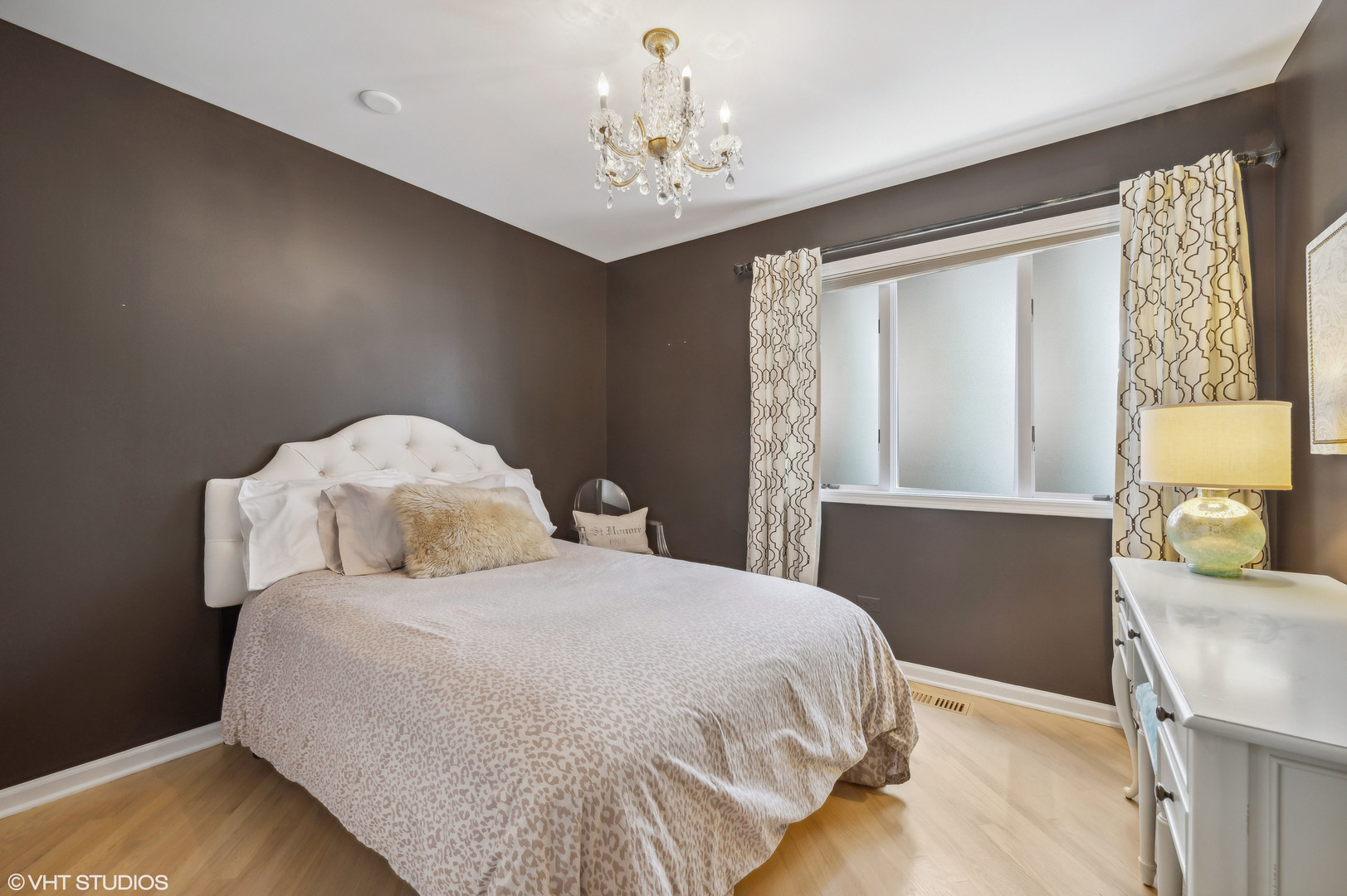 55 West Goethe Street, Unit 1251 Chicago, IL 60610 - Photo 24 of 28 a bedroom with a bed and a chandelier