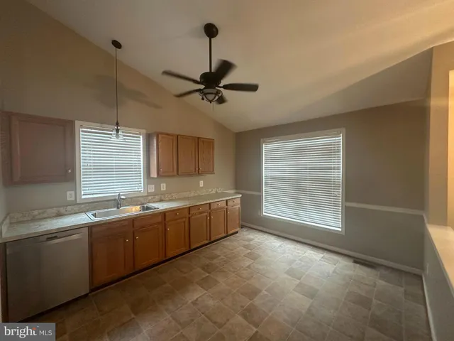 a large kitchen with a large window and stainless steel appliances