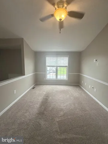 an empty room with a empty space and a ceiling fan